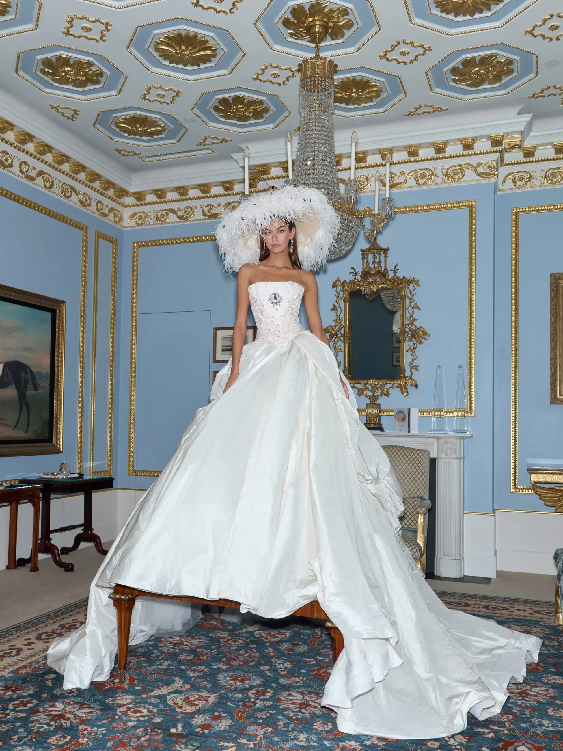 model is wearing a strapless ball gown wedding dress
