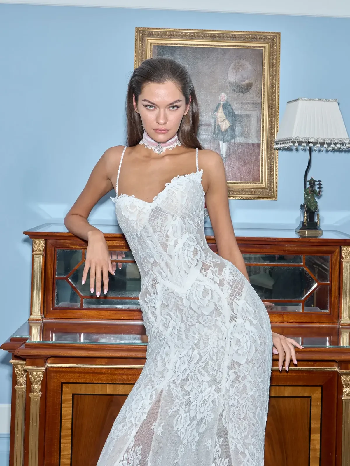 model is wearing a spaghetti strap lace bridal gown