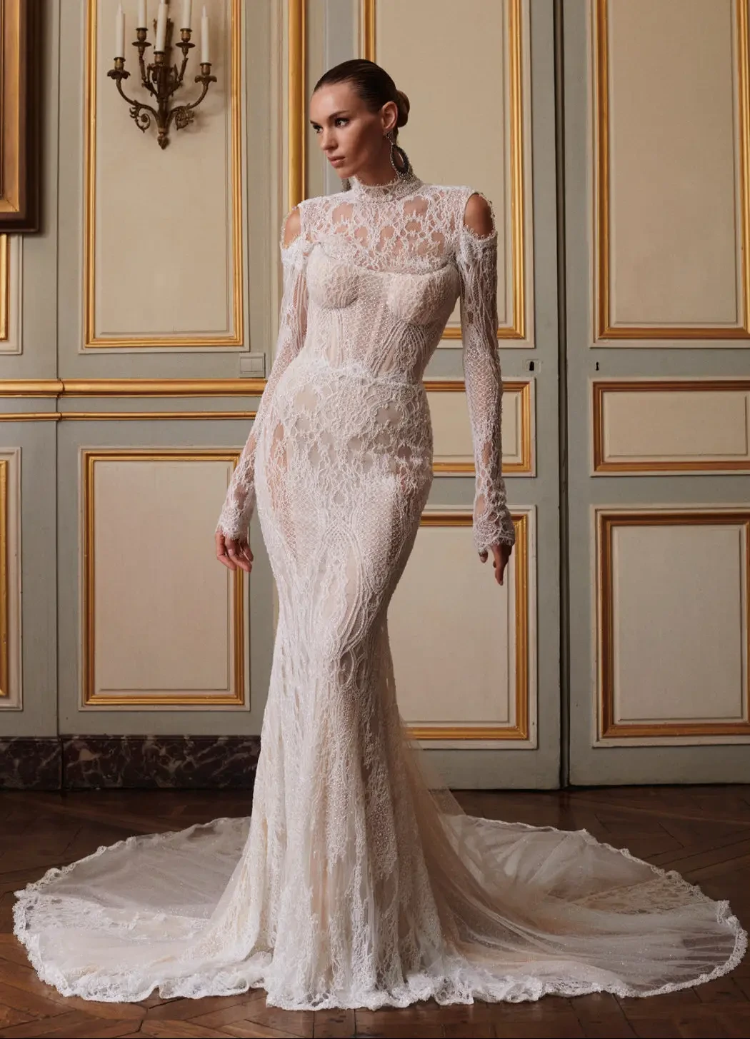 model is wearing an allover lace long sleeve bridal gown