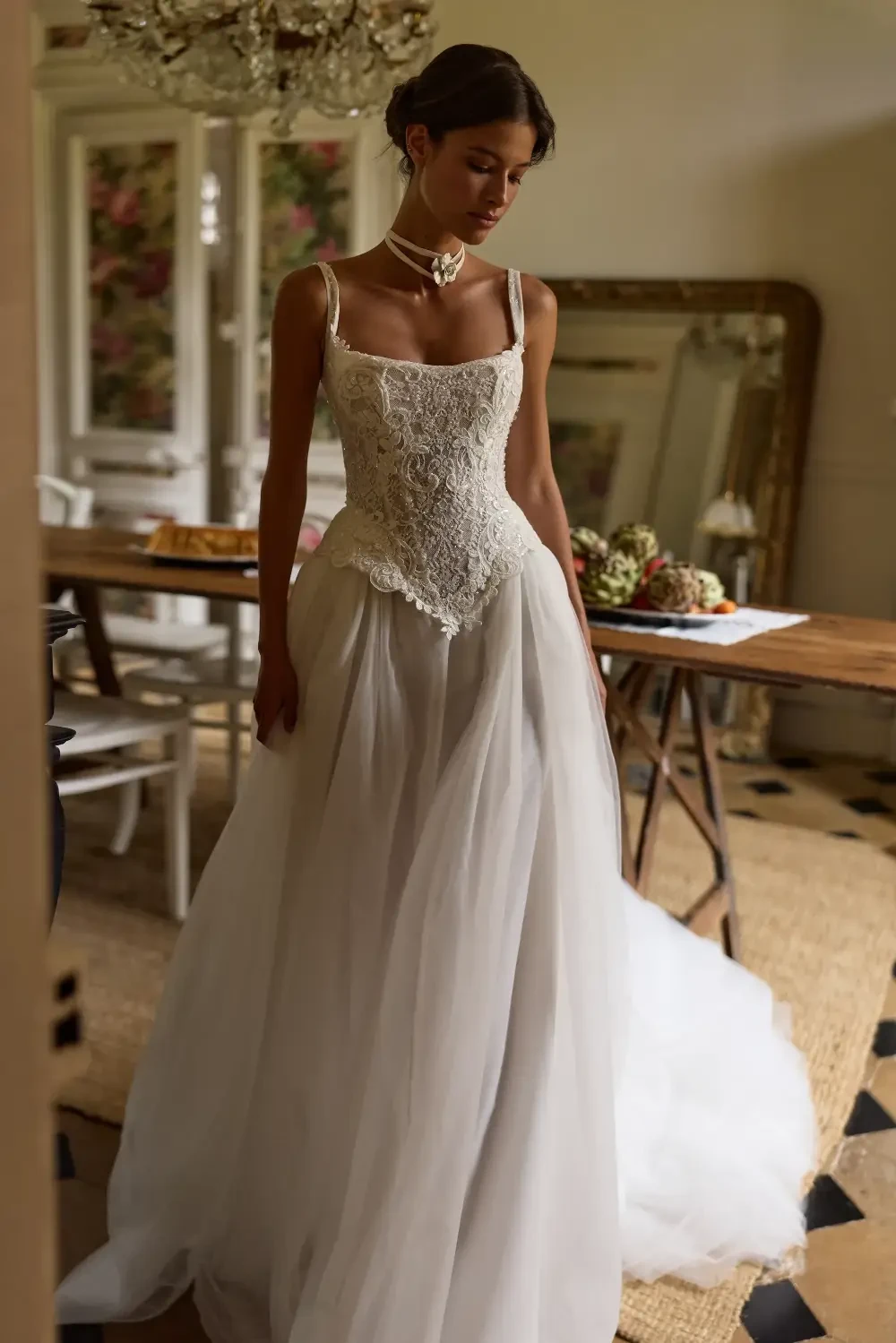model is wearing a sleeveless basque waist wedding gown