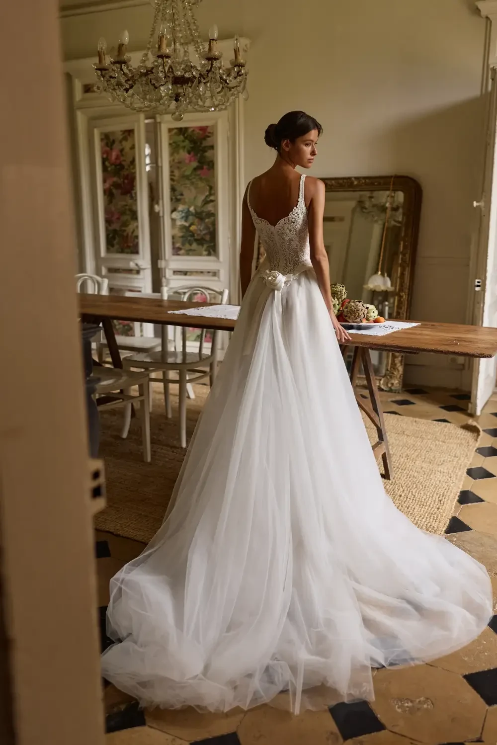 model is wearing a sleeveless basque waist wedding gown