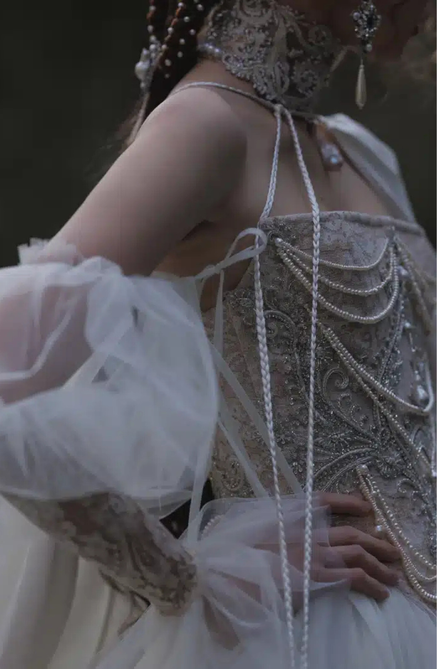 model is wearing a beaded pearl wedding dress by kim kassas