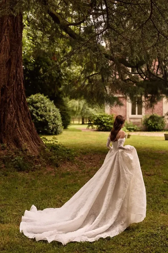 model is wearing a strapless ball gown with detachable sleeves